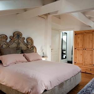 a bedroom with a large bed with pink pillows at Tuscany Garden Inn - Boutique B&B in Castel San Pietro Terme +29 photos