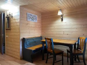 a dining room with a table and chairs at Burger Trostyan Guest House in Slavske