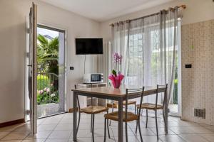 a dining room with a table and chairs and a window at Agritur Laura in Nago-Torbole