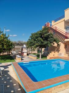 a swimming pool in front of a building at Apartamento ILA in Gandía