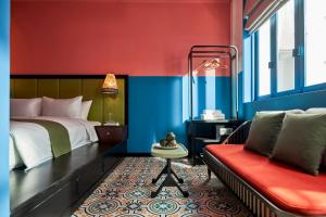 a bedroom with a bed and a red and blue wall at Dakao Vibe Studios by CIRCADIAN in Ho Chi Minh City
