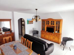 a living room with a couch and a table at Los Deseos De Vera in La Cala de Mijas