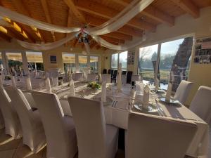 a large dining room with a long table and chairs at Land-Gut-Hotel- Weisser Schwan in Zossen