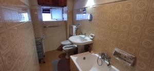 a small bathroom with a sink and a toilet at Casa Zanetti in Bovegno