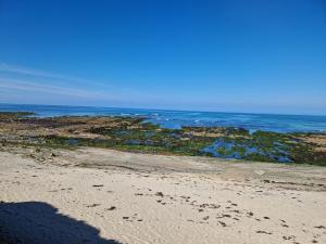 a shadow of a person on the beach at maison plain pied in Pouldreuzic
