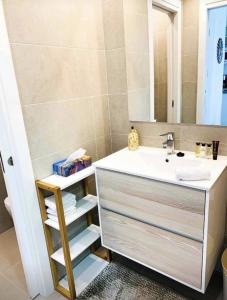 a bathroom with a sink and a mirror at Sol Blanco in Arenales del Sol +23 photos
