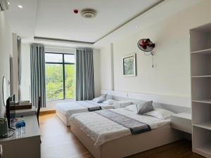 ein Schlafzimmer mit zwei Betten und einem Fenster in der Unterkunft Hue Panorama Villa in Cư Chinh + 63 Fotos