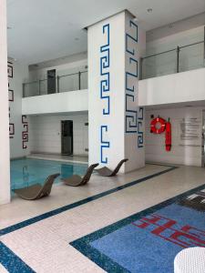 a swimming pool with chairs in a building at Makati City Centre Condo in Manila