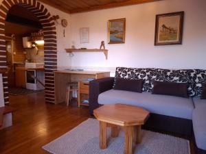 a living room with a couch and a table at Fairytale Cottage - Peaceful Getaway Near Bled in Zgornje Gorje