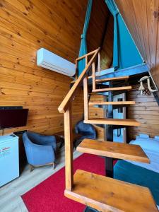 a spiral staircase in a room with wooden walls at Loya Butik Otel Bungalov in Rize +25 photos
