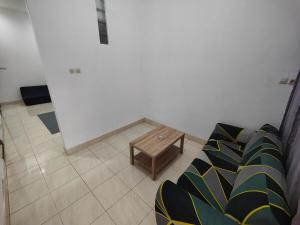 a living room with a couch and a coffee table at Pet Friendly - KenVan Homestay Cirebon in Ciperna +2 photos