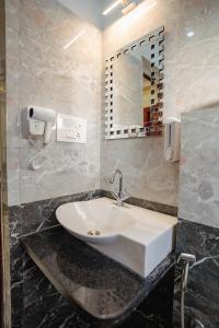 a bathroom with a sink and a mirror at The OG Stay - Luxury Apartment Ajmer in Ajmer +47 photos