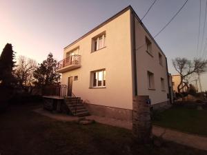a house with a staircase on the side of it at Apartament Mickiewicza in Rumia