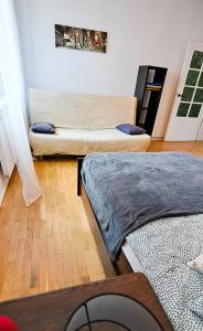 a living room with two beds and a couch at Apartament Mickiewicza in Rumia