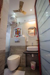 a bathroom with a toilet and a sink at The OG Stay - Luxury Apartment Ajmer in Ajmer