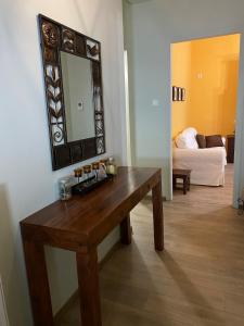 a room with a wooden table and a mirror at House Aeriko in Alonnisos Old Town +8 photos