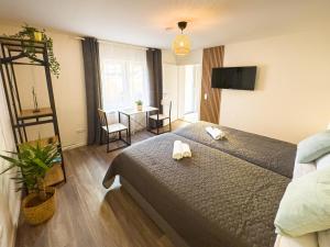 a bedroom with a bed with two towels on it at ImmoStay M#Apartments Waterfront - WiFi & Parking in Bremen