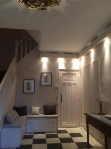 a room with a staircase with a couch and a door at House facing Roland Garros stadium - 5 bedrooms in Boulogne-Billancourt