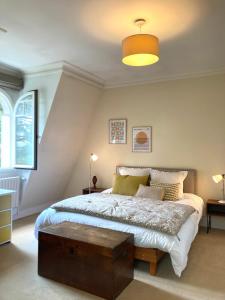 a bedroom with a large bed with a wooden table at House facing Roland Garros stadium - 5 bedrooms in Boulogne-Billancourt +117 photos