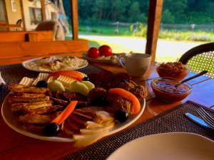 a plate of food on a wooden table at Green Mountain Resort in Scrind-Frăsinet