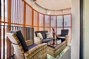 a balcony with two chairs and a table at Baltic Waves Resort by Baltic Home in Międzyzdroje +159 photos