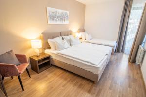 a hotel room with a bed and a chair at Penzion Šterk in Most na Soči