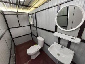 a bathroom with a toilet and a sink and a mirror at Ploy&Praew โดม 2 in Ban Sop Mae Klang