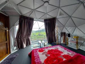 a bedroom with a large bed with red flowers on it at Ploy&Praew โดม 2 in Ban Sop Mae Klang