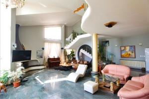a living room with pink furniture and a staircase at Къща за гости,, Зафир,, in Sofia