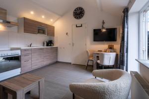 a kitchen with a table and a dining room at Hello Zeeland - Vakantiehuis Wijngaardstraat 12A in Domburg