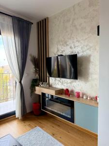 a living room with a flat screen tv on a wall at Apartman Njegoš Lux Titova vila in Palisad
