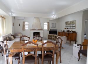 a living room with a table and a couch at Poulakis House in Asini