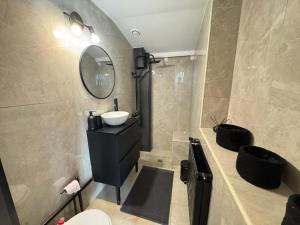 a bathroom with a sink and a mirror at Maison 2ch - Netflix - Fléchettes - Hyper centre in Douai +23 photos