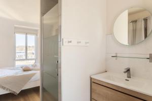 a bathroom with a sink and a mirror at L'Abri Côtier d'Argäe - Terrasse vue mer in Erquy