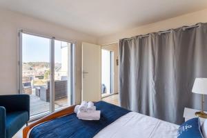 a bedroom with a bed with a towel on it at L'Abri Côtier d'Argäe - Terrasse vue mer in Erquy