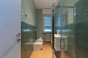 a bathroom with a toilet and a sink and a shower at I Host Apartment - Coni Zugna 58 in Milan +21 photos