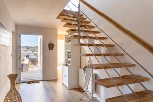 a staircase in a home with wooden treads at L'Abri Côtier d'Argäe - Terrasse vue mer in Erquy