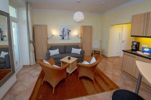a living room with a couch and a table at Villa Malepartus - Wohnung 03 in Binz