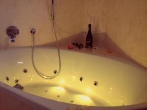 a bath tub with a bottle of wine in it at Gästehaus am Fischerweg in Lauterbach
