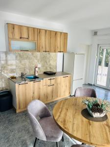 a kitchen with a table and chairs and a refrigerator at TOP view Apartment Budva in Budva +3 photos