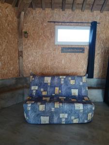 a bed sitting in a room with a window at Le Manège in Thiétreville