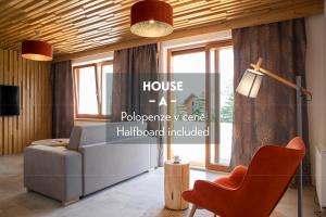 a living room with a couch and a chair at Amenity Hotel & Resort Lipno in Lipno nad Vltavou
