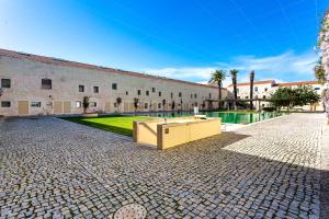 a large building with a pool in a courtyard at Tavira Convent, 2-bedroom, condo, pool in Tavira