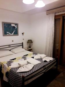 a bedroom with a bed with towels on it at Roptro Rooms in Parga +11 photos