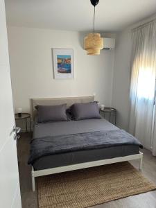 a bedroom with a bed in a room at Casa Juliette Maison bois in Aléria +2 photos