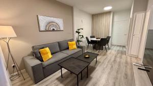 a living room with a couch and a table at SeaBreeze City Center Flats by TrulyCyprus in Limassol