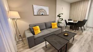 a living room with a couch and a table at SeaBreeze City Center Flats by TrulyCyprus in Limassol