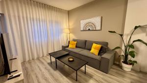 a living room with a couch and a table at SeaBreeze City Center Flats by TrulyCyprus in Limassol