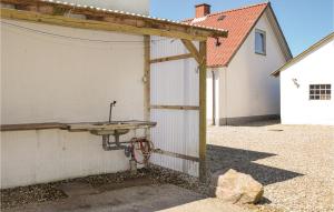 a white garage with a wooden roof and a sink at Holiday Home Longelsevej in Illebølle +12 photos