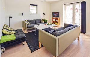 a living room with two couches and a table at Two-Bedroom Apartment In Grasten in Gråsten